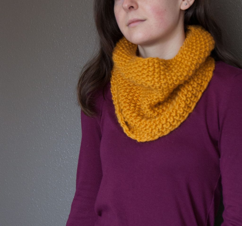 modeled seed stitch cowl in mustard yarn