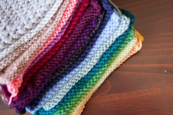 knit swatches of acrylic yarns in rainbow color